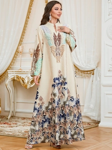Close-up of elegant floral print and satin texture on a long-sleeved kaftan dress