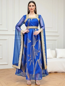 Detail of royal blue embroidered maxi dress with golden leaf patterns and lace trim