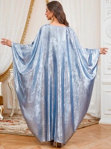 Detail view showing metallic texture and flowing drape of light blue kaftan dress back