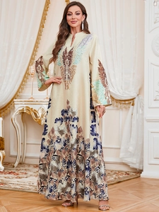 Detailed view of elegant beige satin maxi robe with peacock feather patterns and floral prints