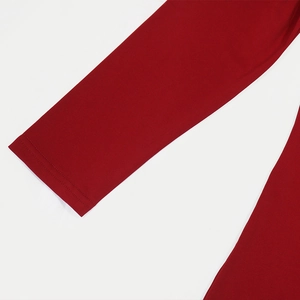Detailed close-up showing the neat double-needle stitching on red long sleeve cuffs