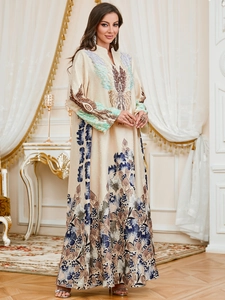 Close-up of floral print and embroidery on long-sleeved satin A-line maxi dress