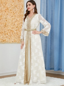 Detailed embroidery and gold lace trim on a white V-neck long-sleeve Kaftan dress