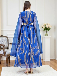 Detailed view of elegant blue robe with golden leaf embroidery and sheer cape sleeves