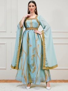 Light blue embroidered maxi dress with golden floral patterns and lace trim details