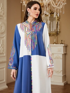 Detailed view of colorful embroidery and color-block stitching on this elegant kaftan robe