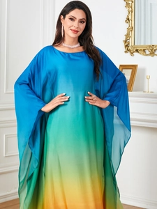 Detail of blue-green-yellow gradient maxi dress featuring flowy batwing sleeves and round neck