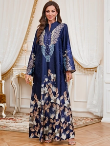 Deep blue long-sleeved kaftan dress featuring ornate feather embroidery and floral patterns