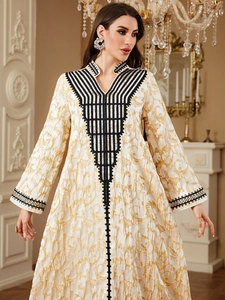 Elegant beige V-neck kaftan with golden patterns and intricate black geometric embroidery