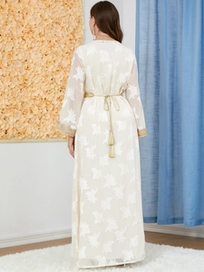Detail of white long sleeve maxi dress with gold floral embroidery and sequins