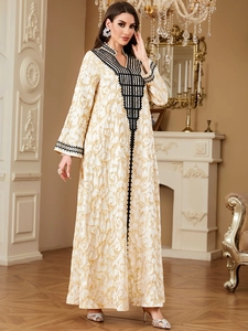 Elegant beige kaftan dress with golden jacquard patterns and black lace V-neck embroidery