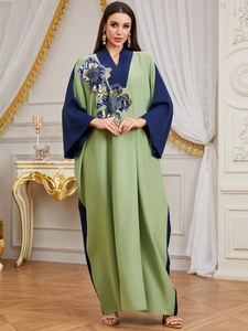Green V-neck kaftan abaya for women featuring contrast sleeves and sequin floral embroidery