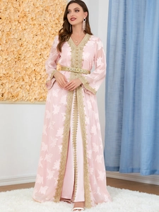 Detailed embroidery and gold lace accents on a pink long-sleeved Kaftan gown