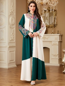 Elegant color block kaftan with embroidery and tassels on a cream and dark green dress