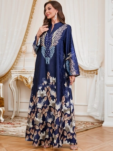 Detailed embroidery and white beaded accents on a luxury navy blue kaftan robe