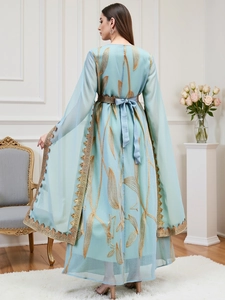 Detail of light blue embroidered dress with golden lace trim and bow ribbon at the back