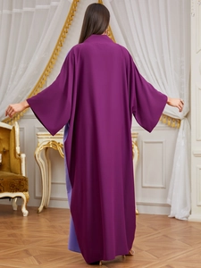 Back view of a loose purple long robe with kimono sleeves in an elegant interior
