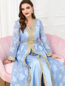 Detail of light blue Kaftan with intricate gold embroidery and white leaf patterns