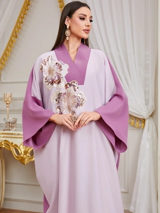 Close-up of contrast color kaftan with 3D floral sequins and beaded embroidery detail