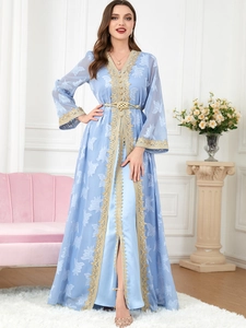 Detail of light blue kaftan with intricate gold embroidery and elegant braided belt