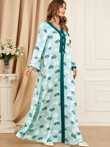 Detail of V-neck printed long sleeve maxi dress with green floral pattern and buttons
