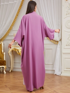 Rear view of long mauve kaftan maxi dress with loose fit and elegant draped silhouette