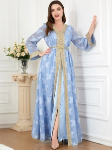 Detail of light blue kaftan dress featuring gold embroidered trim and floral lace texture