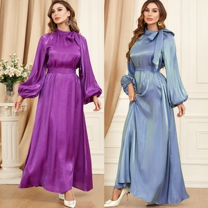 Detail of silk satin maxi dress featuring lantern sleeves and a belted waistline