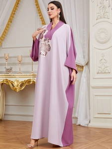 Detail of floral sequin embroidery and color-block stitching on the loose V-neck robe