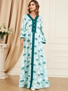 Detail of V-neck collar and palm leaf print on elegant mint green long sleeve maxi dress