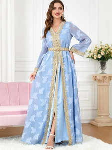 Detail of light blue V-neck kaftan dress with white floral pattern and gold sequin embroidery