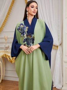 Detail showing colorful sequin floral embroidery on a V-neck patchwork robe