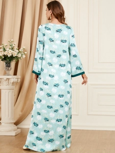 Rear view of mint green floral maxi dress with elegant bell sleeves and loose fit design