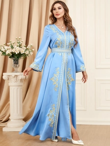 Close-up of elegant sky blue satin maxi dress featuring intricate gold embroidery detail