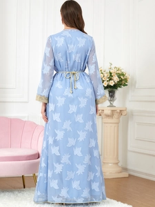 Back view of light blue V-neck maxi dress with floral textures and gold fringe belt