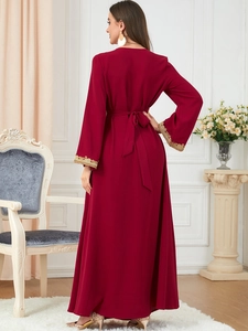Detail of burgundy maxi dress with gold embroidery on cuffs and matching belt back view