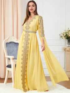 Detailed golden embroidery on long yellow kaftan dress with elegant V-neck and split sleeves