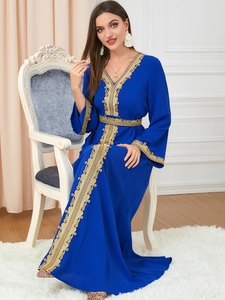 Close-up of golden embroidery details on royal blue long-sleeve Abaya dress