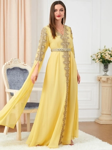 Detail of golden embroidery on yellow Moroccan kaftan dress with long sleeves