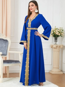 Detail of royal blue kaftan robe showing golden geometric embroidery on sleeve and waist