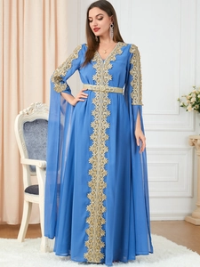 Detail of royal blue kaftan with gold lace embroidery and elegant flared shawl sleeves