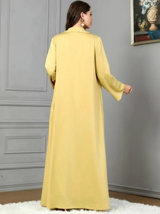 Rear view of an elegant yellow long-sleeved lapel coat with a minimalist silhouette