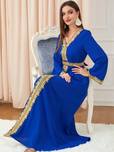 Detailed view of royal blue kaftan featuring gold lace embroidery and long sleeves