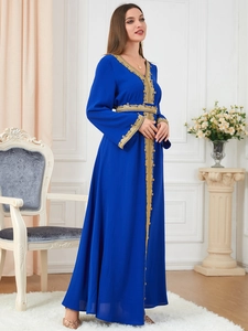 Detail of elegant gold embroidery on the neckline of a navy blue long sleeve robe dress