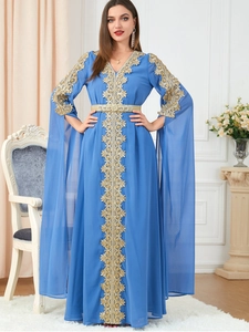 Close-up of gold floral embroidery on light blue chiffon kaftan dress with bell sleeves