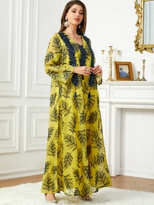 Élégante robe longue jaune à fleurs avec broderie bleue et détails de glands