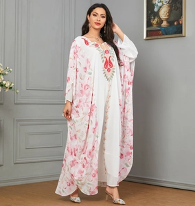Close-up of elegant floral print and intricate embroidery on a kaftan dress