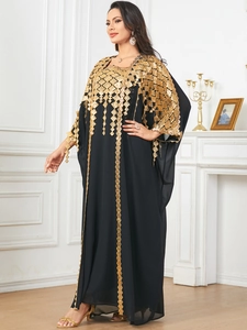 Detailed view of black chiffon kaftan with golden geometric embroidery and sequins