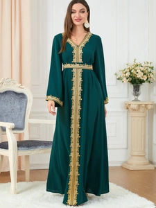 Detail of golden embroidery patterns on the neckline and cuffs of the dark green robe