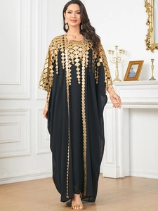Detail of elegant black kaftan with golden sequin embroidery and geometric patterns